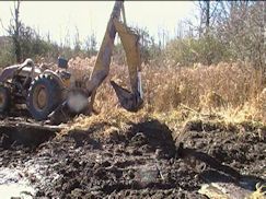 Backhoe ready at secondary dam